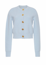 The Ellery Cardigan by Cara Cara is a light blue, long-sleeve fitted cardigan featuring gold floral buttons, shown on a plain white background.