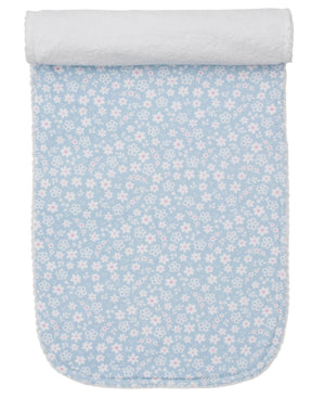 The Kissy Kissy Fall in Bloom Burp Cloth is a rectangular blue Pima cotton cloth with a white floral pattern, rolled at one end and displayed on a white background.