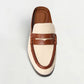The Simkhai Dean Canvas Como Loafer Mule is shown from above, displaying its stylish slip-on design with a beige fabric upper and brown leather trim and details against a plain white background.