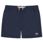 The Mens Plain Trunks by Pink House Mustique are navy blue swim shorts designed with an elastic waistband, a light pink drawstring, and a small pink palm tree graphic on the lower left leg. Combining convenience and style, these trunks also feature a secure Velcro back pocket for your essentials.