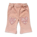 The Louis Louise Baby Girls’ Holly Trouser in powder pink corduroy, designed for toddlers, features an elasticated waist and charming heart-shaped knee patches with floral details, shown on a white background.