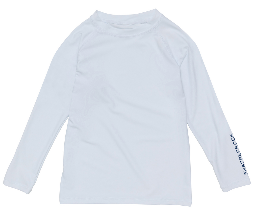 The Boys' LS Rash Top by Snapper Rock is a plain white rash top featuring the brand logo on the lower sleeve, designed for sun safety during any coastal blue adventure.