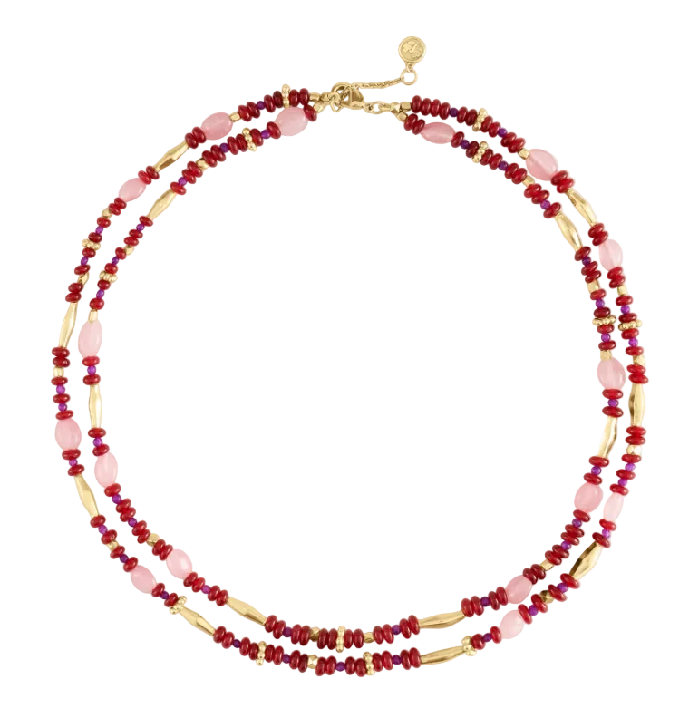 Milos Beaded Necklace featuring double strands of red, pink, and metallic gold beads with a gold lobster clasp, styled like a turquoise and lapis lazuli accessory.