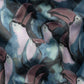 Eton's Tucano Swim Shorts feature an abstract pattern with playful stylized toucans, pink beaks, and dark blue feathers on a cloudy blue-gray background, crafted in fast-drying polyester.