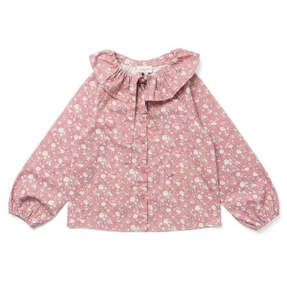 The Girls’ Angele Shirt by Louis Louise features a pink long-sleeve floral print with a white floral pattern, front buttons, ruffled collar, and tie detail—displayed on a white background, this charming tunic is expertly crafted for girls’ comfort and style.