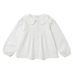 The Girls’ Ester Shirt by Louis Louise is a white long-sleeve blouse with a lace-trimmed Peter Pan collar, pintuck detailing on the front, and buttons at the neckline.