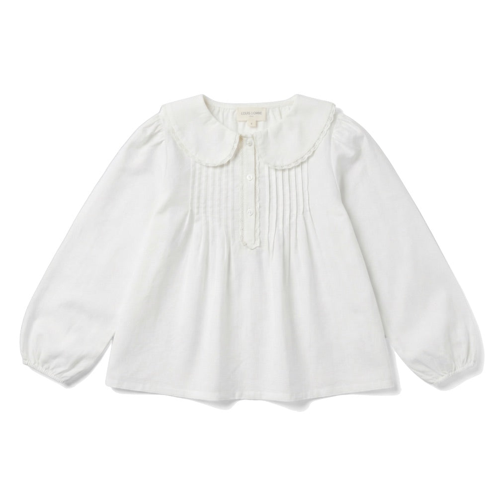 The Girls’ Ester Shirt by Louis Louise is a white long-sleeve blouse with a lace-trimmed Peter Pan collar, pintuck detailing on the front, and buttons at the neckline.