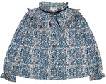 The Girls' Imani Twill Cashmere Tunic by Louis Louise features long sleeves, printed blue paisley and floral designs, a ruffled collar, front tie, and elasticized cuffs.