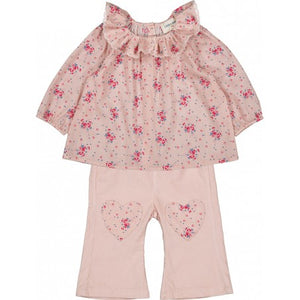 The Louis Louise Baby Girls' Lissou Cotton Veil Romantic Flower Tunic features a pink floral design with long sleeves and a ruffled lace collar, styled with light pink pants accented by heart-shaped knee patches.