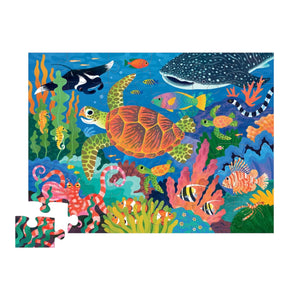 The Crocodile Creek Sea Turtle Puzzle is a vibrant 36-piece floor puzzle featuring sea life and is made from recycled cardboard, with one missing piece in the bottom left corner.