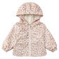 The Quincy Mae Baby and Kids’ Rain Coat is a light-colored toddler raincoat with a pink floral pattern, hood, front zipper, two pockets, airflow flap for breathability, and elastic cuffs, displayed on a plain white background.