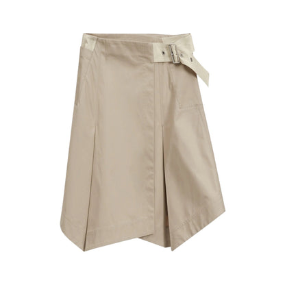 The 3.1 Phillip Lim Two-Toned Handkerchief Wrap Skirt features an architectural hemline, front pleats, and a side buckle belt detail, shown on a white background.