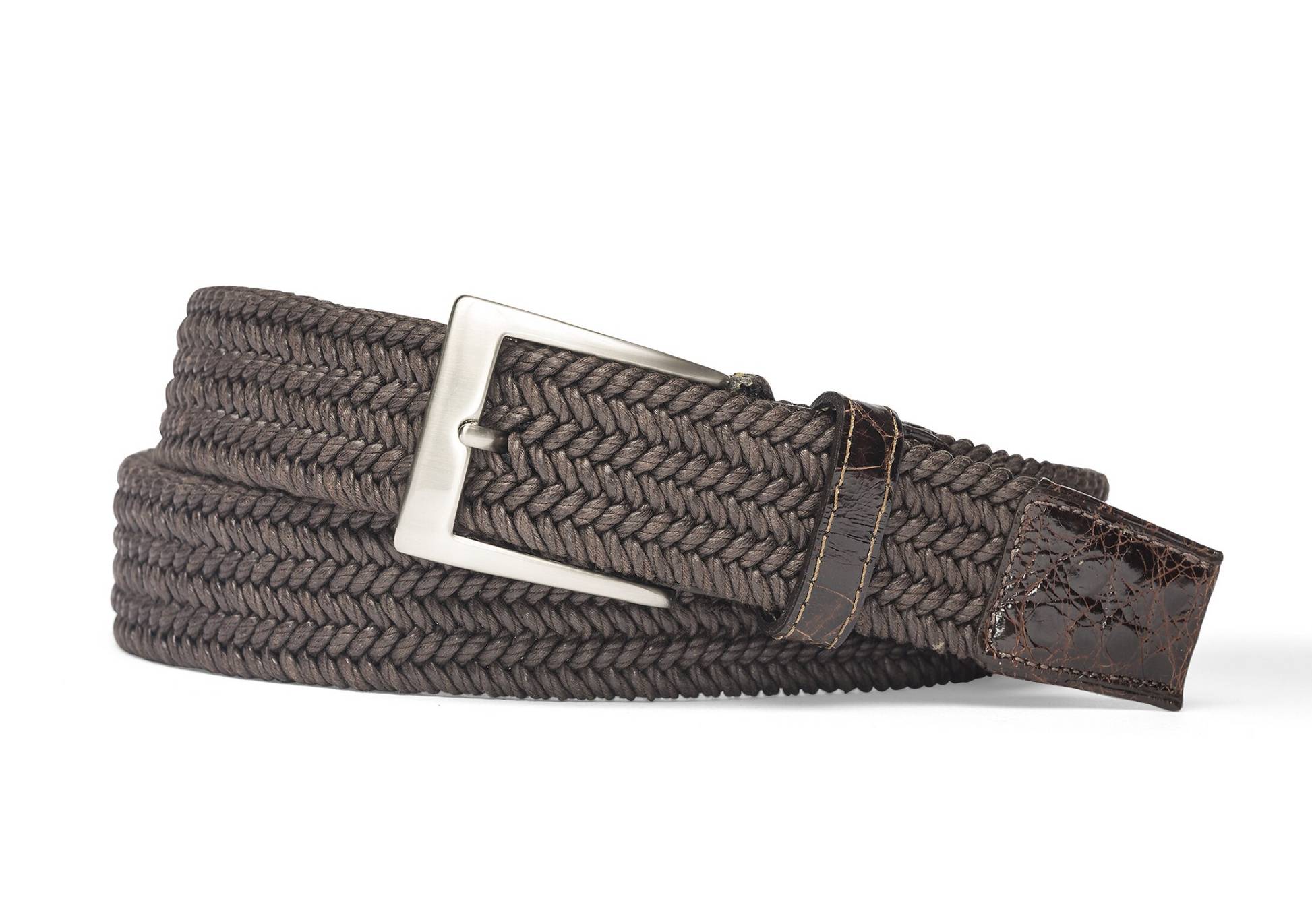 The W. Kleinberg Men's Solid Stretch Belt with Croc Tabs features a braided brown design, a leather end tip, and a silver rectangular buckle, shown coiled on a white background.