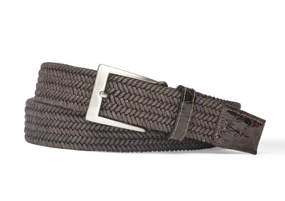 The W. Kleinberg Men's Solid Stretch Belt with Croc Tabs features a braided brown design, a leather end tip, and a silver rectangular buckle, shown coiled on a white background.
