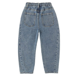 The Girls' Barrel Pant by Rylee & Cru is a blue denim style with an elastic waistband and two back pockets, shown flat with the back side up. Its relaxed fit combines comfort and everyday style.