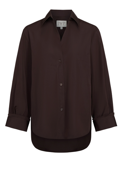 The TWP Next Morning Shirt is a dark brown Italian cotton shirt featuring a relaxed fit, long sleeves, front pocket, cuffed collar, and curved hem.