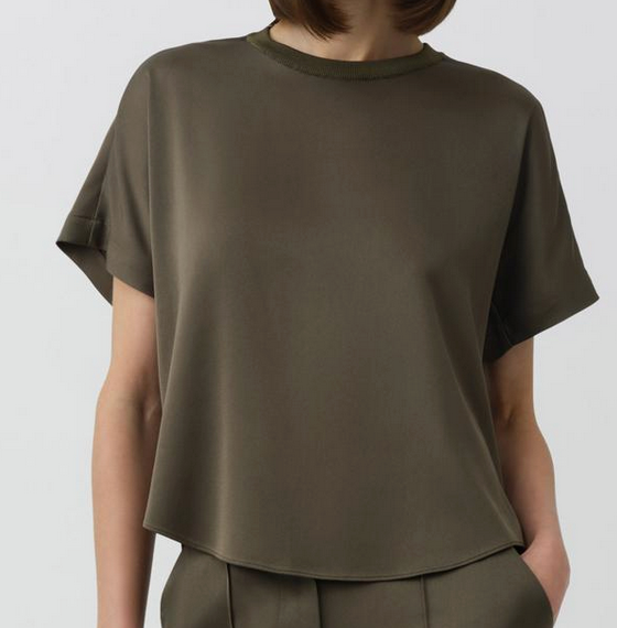 A person wears the Simkhai Addy Satin T-Shirt in olive green, featuring short sleeves and a classic round neckline, paired with matching pants, shown from shoulders to hips against a plain background.
