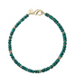 From the Jane Win Gumdrop Beaded Necklace Collection: a beaded necklace with dark green beads, gold spacer rings, a gold clasp, and a round gold tag—style it with a Jane Win pendant for a chic statement.
