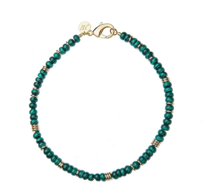 From the Jane Win Gumdrop Beaded Necklace Collection: a beaded necklace with dark green beads, gold spacer rings, a gold clasp, and a round gold tag—style it with a Jane Win pendant for a chic statement.