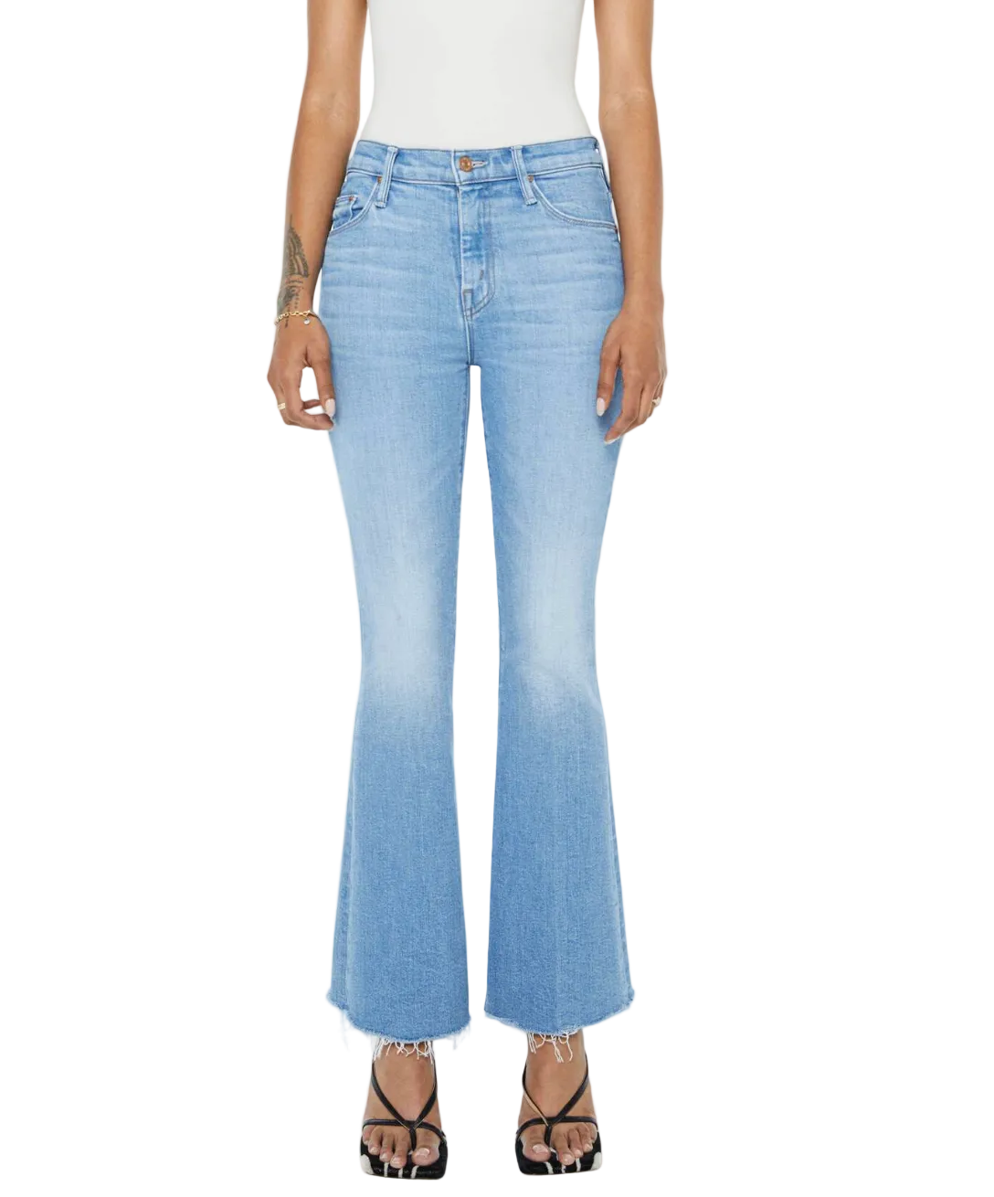 A person stands against a white background wearing Mother’s PETITES Lil Weekender Fray jeans in light blue, styled with a white sleeveless top and black open-toe heels.