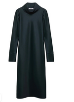 The Shiny Statement Dress by Dorothee Schumacher is a black long sleeve midi with a draped turtleneck and straight silhouette, shown on a white background.