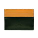 The Ettinger Bridle Flat Credit Card Case is crafted from bridle hide leather with yellow top card pockets, a dark green bottom section, and embossed Ettinger branding on the front.