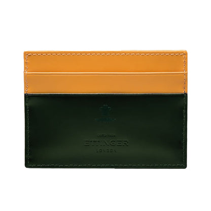 The Ettinger Bridle Flat Credit Card Case is crafted from bridle hide leather with yellow top card pockets, a dark green bottom section, and embossed Ettinger branding on the front.