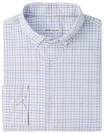 Folded, long-sleeve button-up shirt in a light blue and white checkered pattern, crafted from easy-care fabric. The inner collar label displays the “Peter Millar” brand. Product name: Bruce Crown Lite Cotton.
