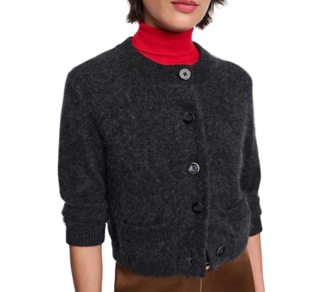 A person wearing the Dorothee Schumacher Fluffy Statements Cardigan in cropped charcoal grey over a red turtleneck and brown pants, shown from shoulders to hips.