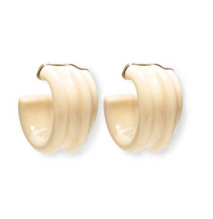 The Lizzie Fortunato Sculpted Hoops are a pair of cream-colored, ribbed resin earrings featuring a smooth, glossy finish and elegant gold-tipped ends.