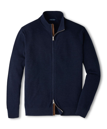 Peter Millar Excursionist Flex Full Zip Sweater in navy blue merino wool with a stand-up collar and tan trim along the zipper.