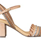 The Ulla Johnson Sofia Sandal is a beige, block-heeled sandal by Ulla Johnson, featuring an elegant ankle strap. Made from vegetable-tanned leather, it boasts intricate braided detailing on the front strap and sides for a touch of sophistication.