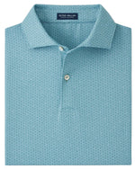 The Peter Millar Corinth Performance Jersey Polo in light blue features a subtle dotted pattern, two white buttons, and four-way stretch for all-day comfort.