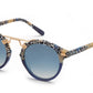 Introducing the Krewe St Louis Mirrored Sunglasses by Krewe: Luxury acetate sunglasses boasting blue gradient lenses, a chic spotted black, white, and beige frame, and 24K gold-plated hardware on the bridge for an elegant touch. Experience both style and unparalleled UVA/UVB protection with every wear.