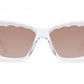 Front view of Krewe Brigitte Sunglasses showcasing a clear frame with wavy edges around the brown-tinted lenses and a stylish cat-eye silhouette.