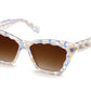 The Krewe Brigitte Sunglasses feature a rectangular luxury design with a checkered frame in blue, beige, and cream colors. The dark brown tinted lenses provide UVA/UVB protection.