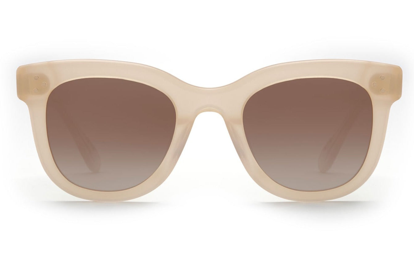 Front view of Krewe Jena Sunglasses featuring beige acetate frames and gradient brown tinted lenses with UVA/UVB protection.