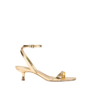 The SK Hannah Leather Sandal by Simkhai features gold straps, a low kitten heel, square toe, and ankle strap, shown on a white background.