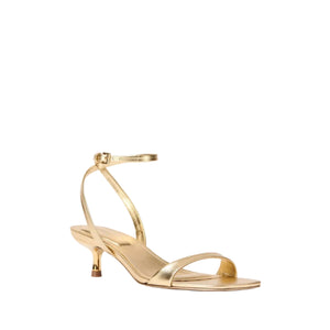 The SK Hannah Leather Sandal by Simkhai is a gold, strappy sandal with a square toe, low kitten heel, and an ankle strap with small buckle, shown against a plain white background.