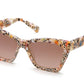 A pair of Krewe Brigitte sunglasses with patterned frames on a white background, offering 100% UVA / UVB protection.