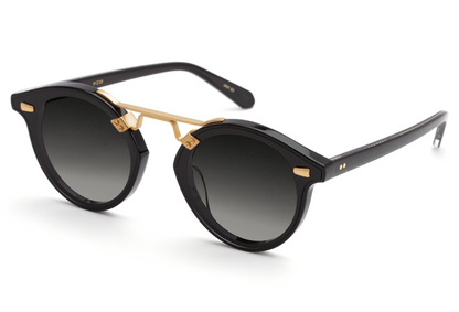 A pair of Krewe STL Nylon Sunglasses with gold accents, handcrafted for a stylish look.