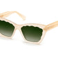 A pair of Krewe Brigitte sunglasses with beige frames and green-tinted lenses, featuring 100% UVA/UVB protection, on a white background.