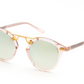 Krewe St Louis Mirrored Sunglasses featuring luxury acetate frames, round green-tinted lenses, 24K gold-plated hardware, and UVA/UVB protection, placed on a white background.