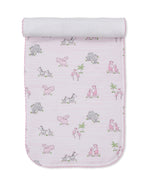 The Kissy Kissy Safari Party Burp Cloth is made from soft Pima cotton and features a charming animal print with zebras, hippos, and flamingos on a white background with pink stripes. It's perfectly versatile to use as a cozy wrap or gentle burp cloth for your baby.