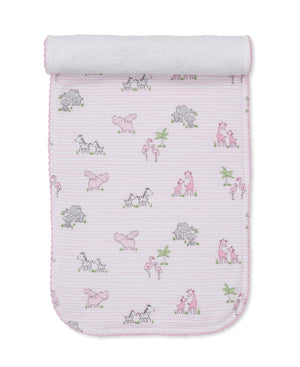 The Kissy Kissy Safari Party Burp Cloth is made from soft Pima cotton and features a charming animal print with zebras, hippos, and flamingos on a white background with pink stripes. It's perfectly versatile to use as a cozy wrap or gentle burp cloth for your baby.