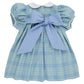 Light blue Audubon Park Plaid Baby Girls’ and Girls’ Mary Dal Dress by The Beaufort Bonnet Company, featuring short puffed sleeves, a white scalloped collar, and a large blue bow tied at the back—perfect for any special occasion.