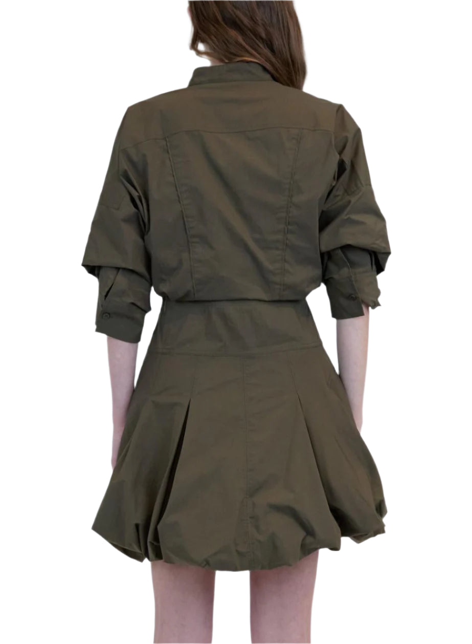 A person wearing the Simkhai Effie Bubble Mini Dress is photographed from the back against a plain light background.