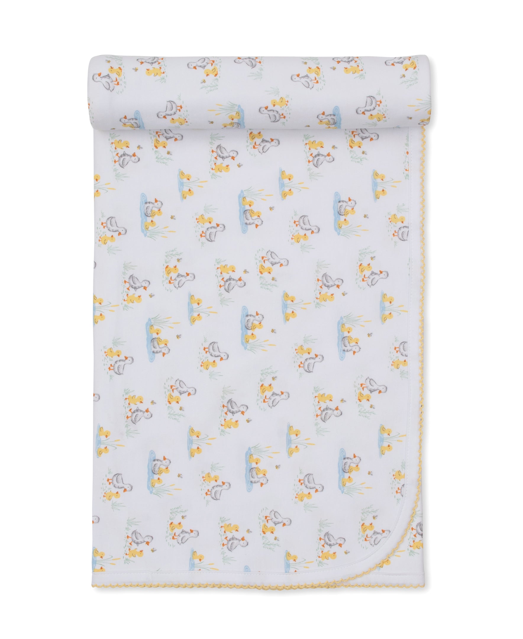 Duck Pond Paddles Blanket by Kissy Kissy, made from soft Pima cotton, showcases a delightful pattern of ducks and is neatly rolled at the top with delicate yellow trim along the edge.