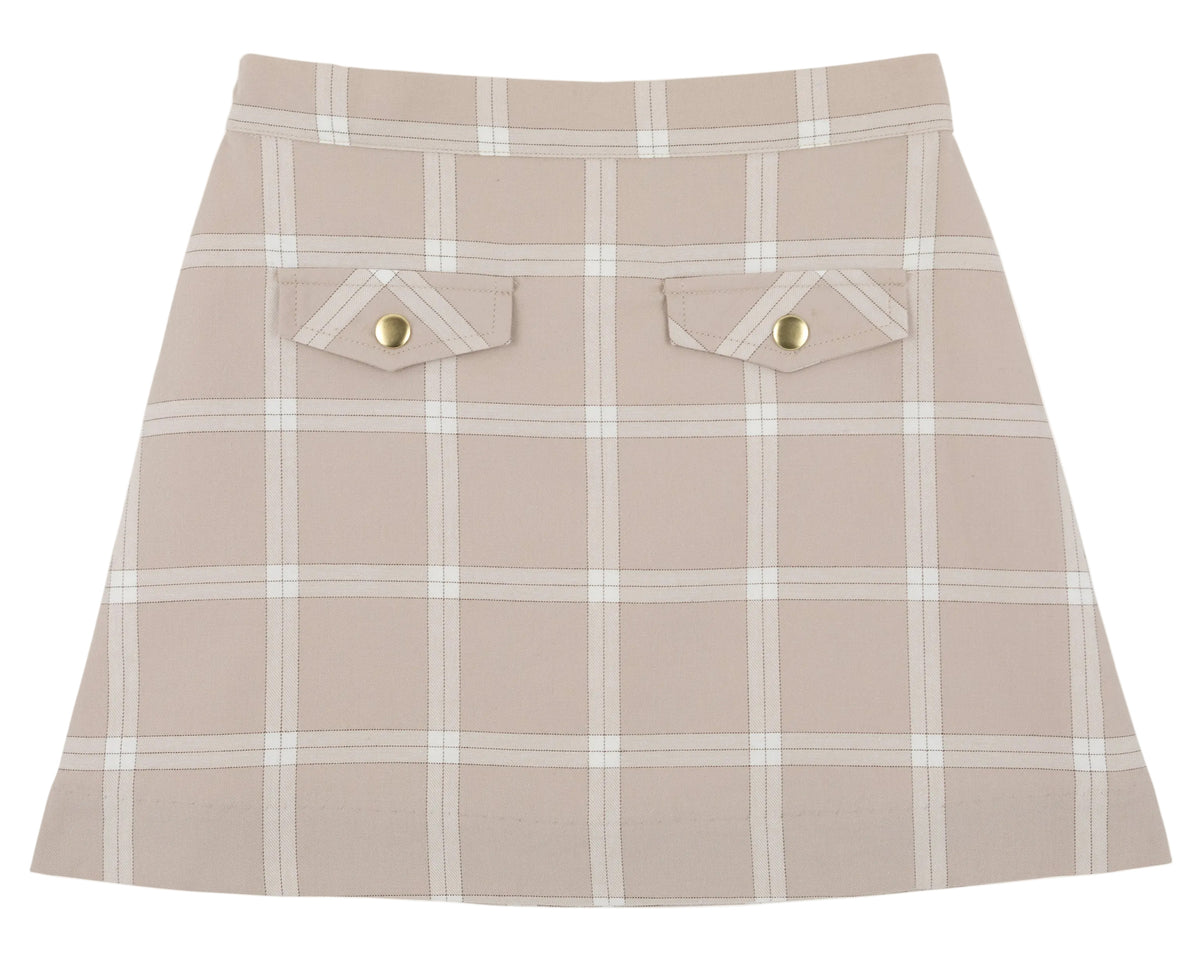 Girls’ Perrin Pocket Flannel Skirt by The Beaufort Bonnet Company, showcasing a beige A-line silhouette with a white Thompson Park Plaid pattern, two front flap pockets, and elegant gold button details.