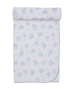 The Sweet Sheep Blanket by Kissy Kissy is a white baby blanket adorned with light blue cartoon animals and sheep, crafted from soft Pima cotton with scalloped edging and neatly rolled at one end.